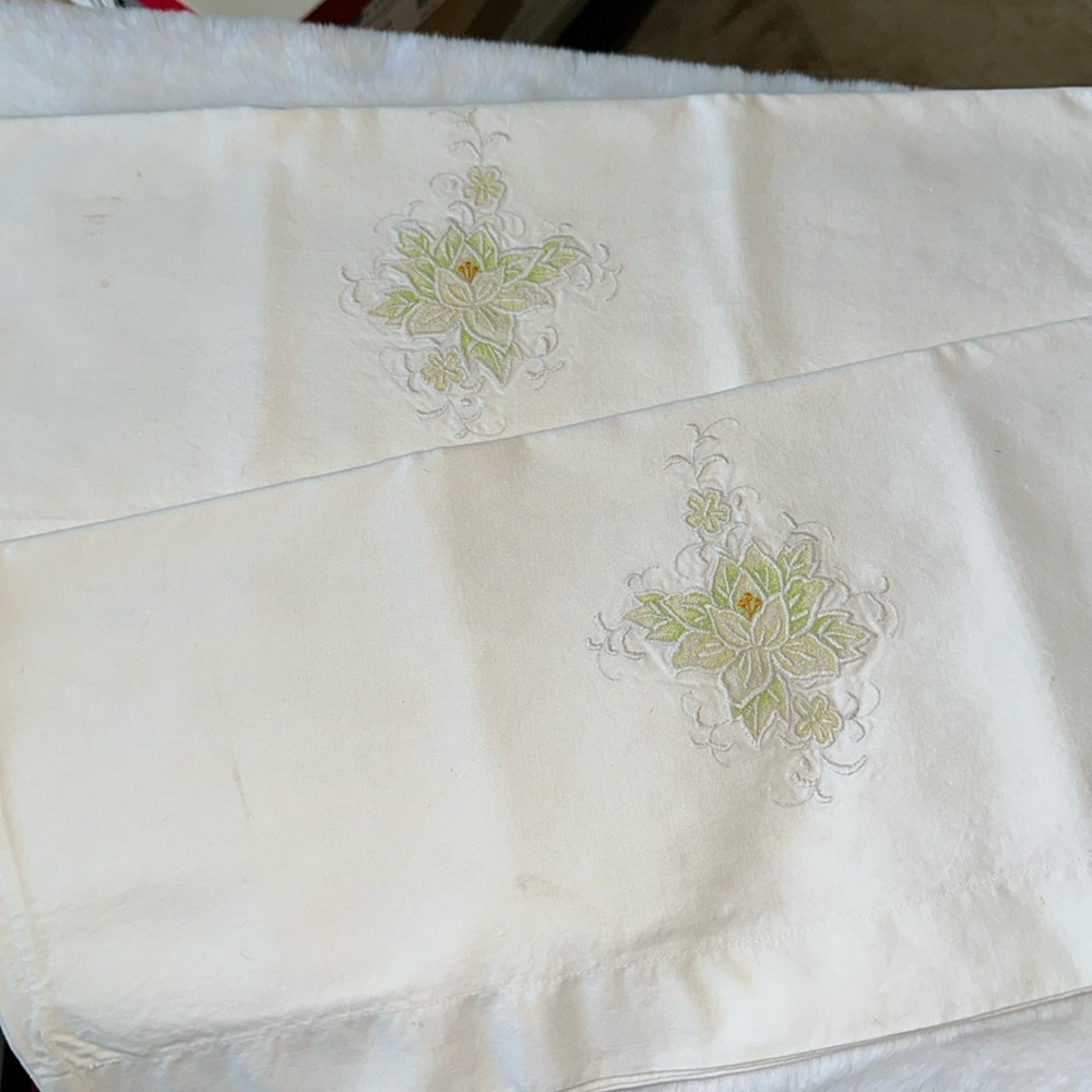 Vintage standard size white pillowcase set with embroidered flower.